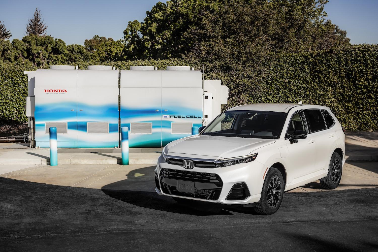 The new Honda CR-V e:FCEV next to the company's demonstration-scale fuel cell power station.